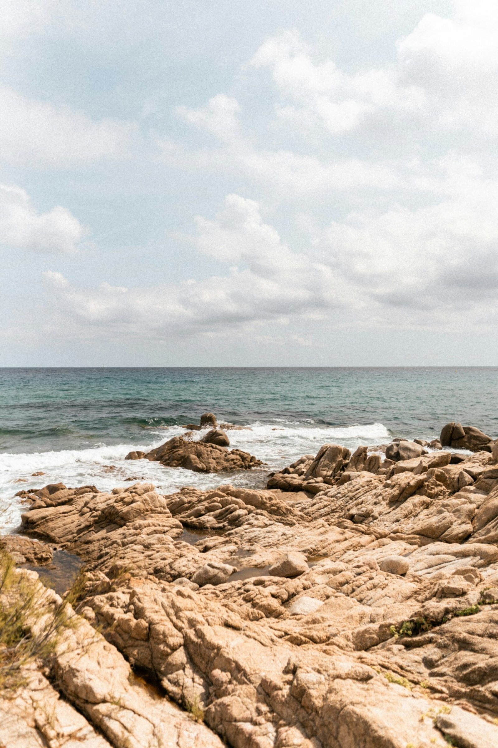 a rocky beach with waves crashing